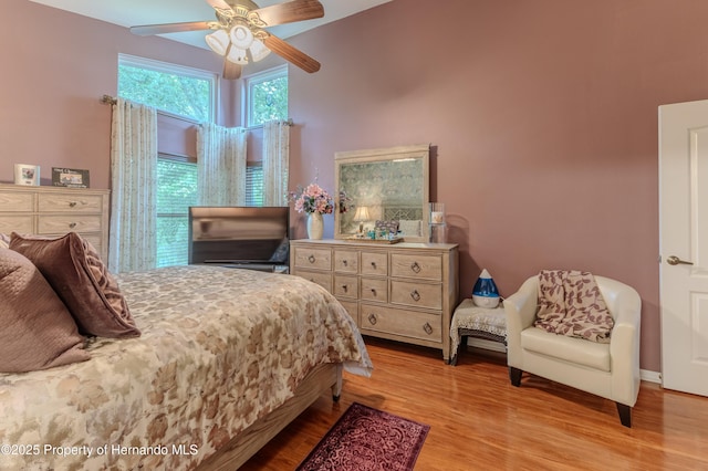 11750 Teapot Ct, Spring Hill, FL 34609 - bedroom featuring wood finished floors and a ceiling fan