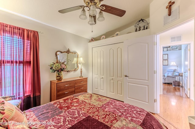 11750 Teapot Ct, Spring Hill, FL 34609 - bedroom featuring a closet, wood finished floors, ceiling fan, and vaulted ceiling