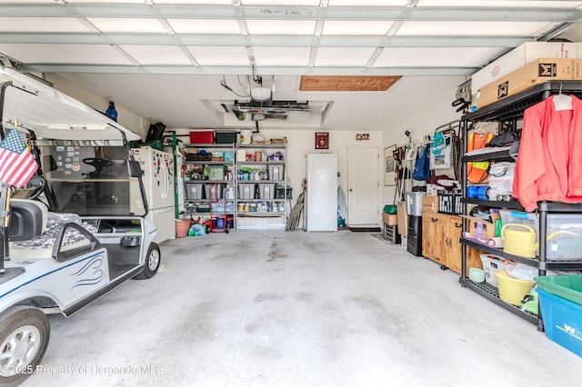 11750 Teapot Ct, Spring Hill, FL 34609 - garage featuring freestanding refrigerator