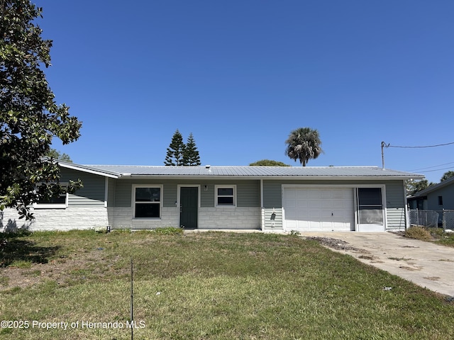 1731 NW 20th Ave, Crystal River, FL 34428 - ranch-style house with concrete driveway, metal roof, and an attached garage
