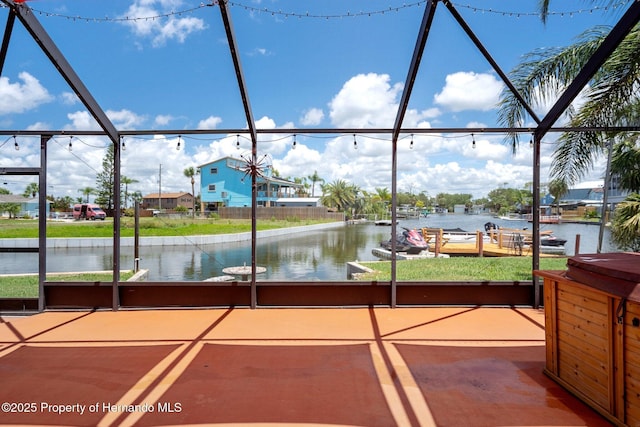 view of patio / terrace with a water view and glass enclosure