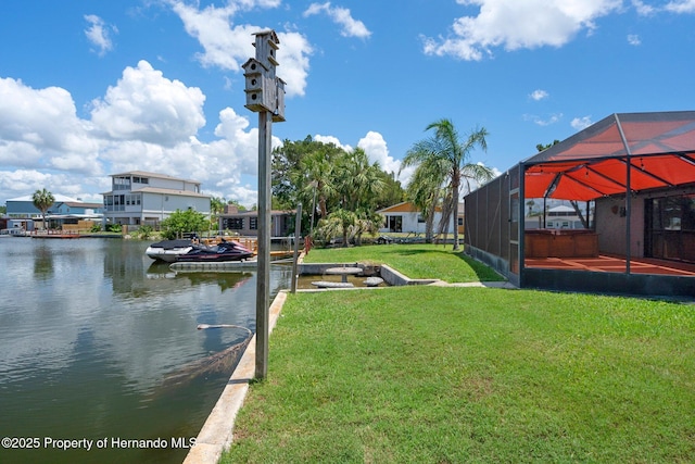 dock area with a water view, a lawn, and a lanai