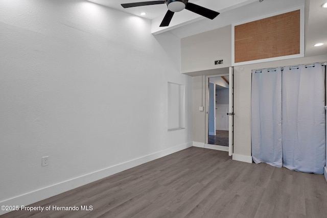 unfurnished bedroom featuring wood finished floors, baseboards, recessed lighting, and a ceiling fan
