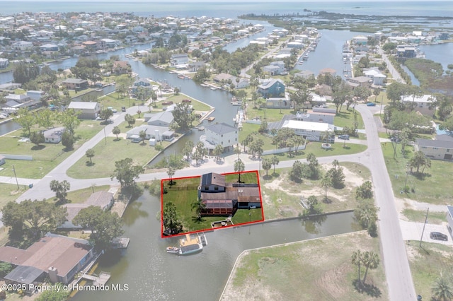 aerial perspective of suburban area featuring a nearby body of water and property boundaries highlighted