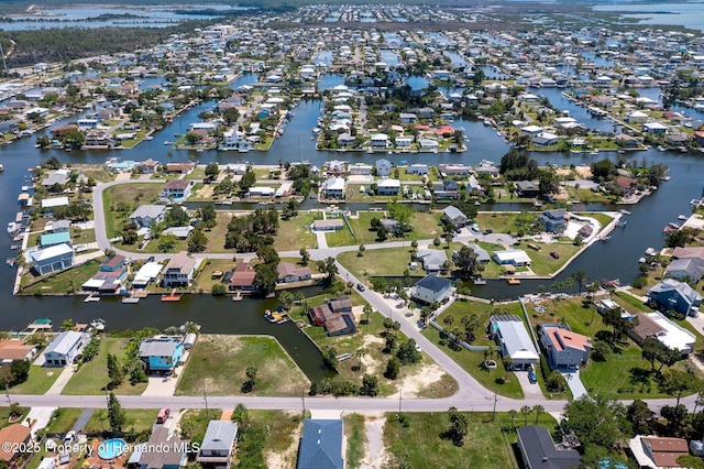 aerial view of property and surrounding area with nearby suburban area and a nearby body of water