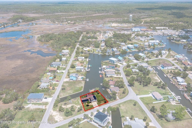 aerial view of residential area with property parcel outlined and a nearby body of water