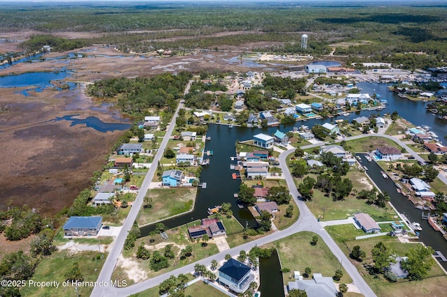 view of property location featuring a nearby body of water and nearby suburban area