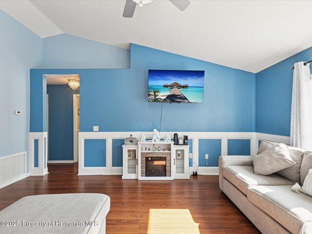 6076 Shiprock Ave, Spring Hill, FL 34608 - living area featuring vaulted ceiling, a wainscoted wall, wood finished floors, ceiling fan, and a chandelier