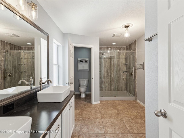 6076 Shiprock Ave, Spring Hill, FL 34608 - full bathroom with toilet, a stall shower, a textured ceiling, double vanity, and baseboards