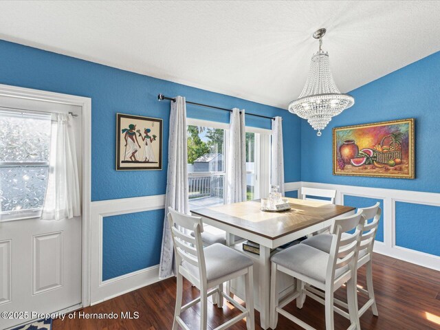 6076 Shiprock Ave, Spring Hill, FL 34608 - dining room featuring a chandelier, wood finished floors, plenty of natural light, baseboards, and a textured wall