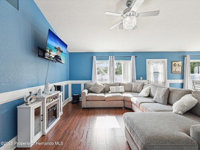 6076 Shiprock Ave, Spring Hill, FL 34608 - living room with a textured ceiling, dark wood-style floors, ceiling fan, and wainscoting