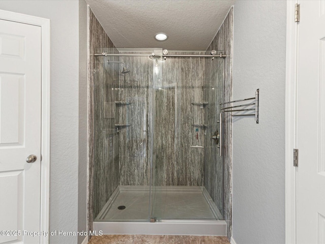 6076 Shiprock Ave, Spring Hill, FL 34608 - bathroom featuring a stall shower, a textured ceiling, and a textured wall