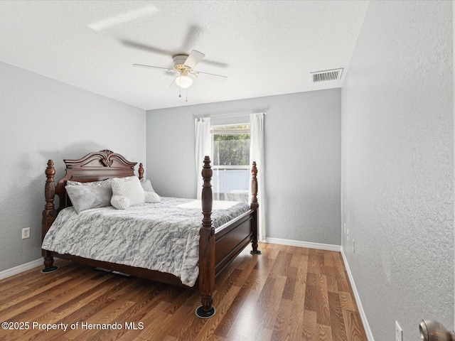 6076 Shiprock Ave, Spring Hill, FL 34608 - bedroom featuring baseboards, wood finished floors, ceiling fan, and a textured wall