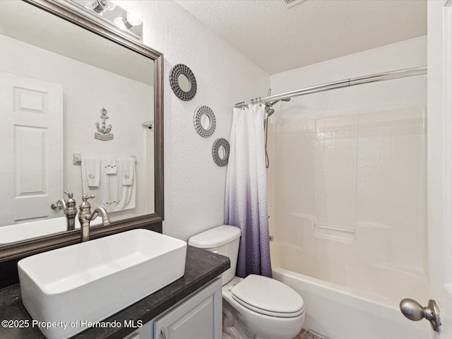 6076 Shiprock Ave, Spring Hill, FL 34608 - bathroom with a textured wall, toilet, vanity, and shower / bath combo