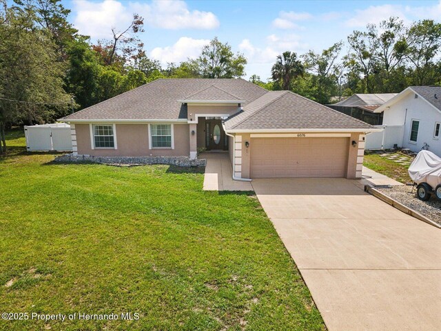 6076 Shiprock Ave, Spring Hill, FL 34608 - view of front of home with stucco siding, a garage, concrete driveway, and roof with shingles
