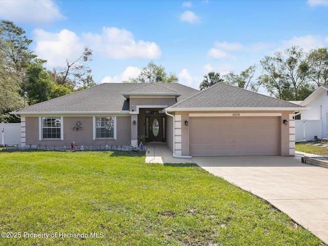 6076 Shiprock Ave, Spring Hill, FL 34608 - view of front of property with stucco siding, a garage, driveway, and a shingled roof