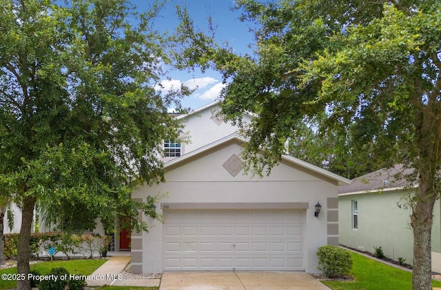 396 Winthrop Dr, Spring Hill, FL 34609 - view of front of home with driveway and stucco siding