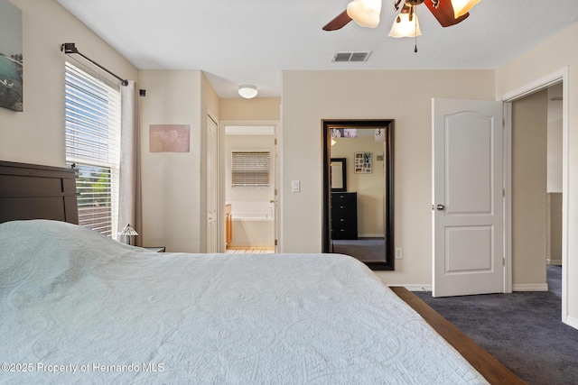 396 Winthrop Dr, Spring Hill, FL 34609 - bedroom with baseboards, connected bathroom, and a ceiling fan