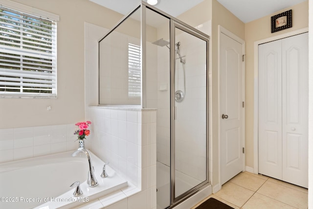 396 Winthrop Dr, Spring Hill, FL 34609 - full bath with a stall shower, healthy amount of natural light, a bath, and tile patterned flooring