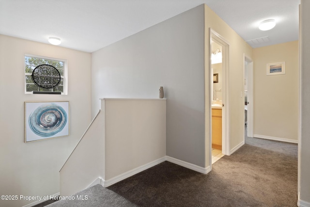 396 Winthrop Dr, Spring Hill, FL 34609 - hallway featuring an upstairs landing, carpet flooring, and baseboards