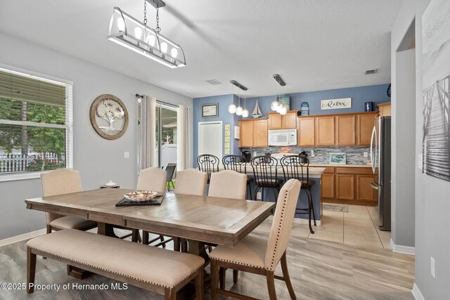 396 Winthrop Dr, Spring Hill, FL 34609 - dining space with baseboards and light wood finished floors