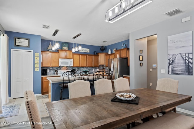 396 Winthrop Dr, Spring Hill, FL 34609 - dining room with baseboards and light tile patterned floors