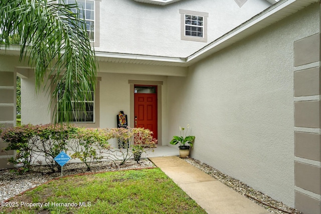 396 Winthrop Dr, Spring Hill, FL 34609 - doorway to property with stucco siding