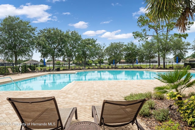 396 Winthrop Dr, Spring Hill, FL 34609 - community pool with fence and a patio