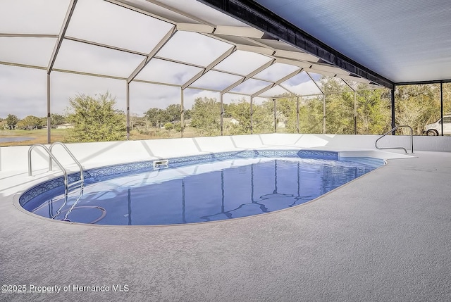 swimming pool featuring a lanai and a patio