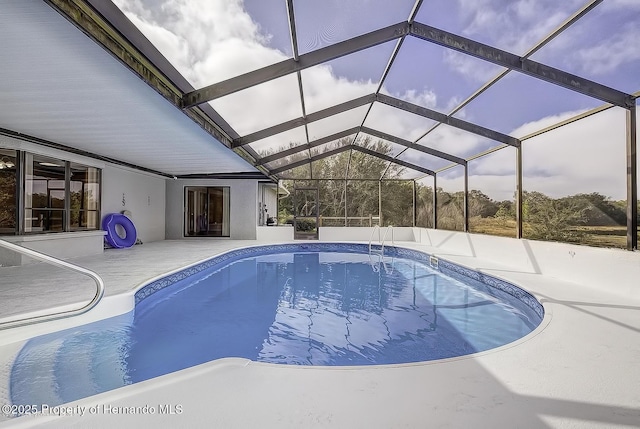 swimming pool featuring a patio and glass enclosure