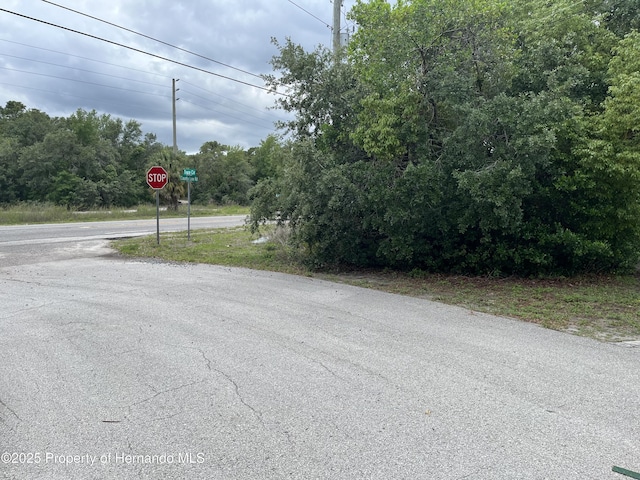 view of asphalt street featuring traffic signs