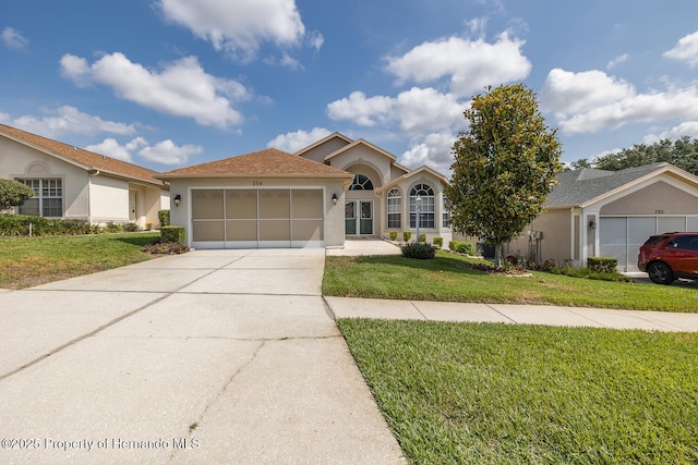 284 Quane Ave, Spring Hill, FL 34609 - single story home with stucco siding, an attached garage, a front lawn, and driveway