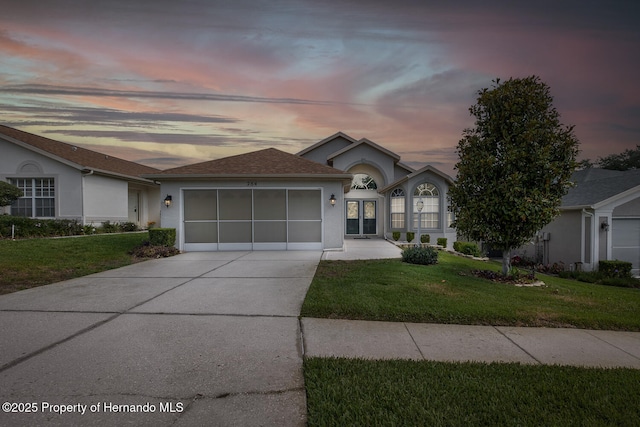 284 Quane Ave, Spring Hill, FL 34609 - ranch-style home featuring a garage, stucco siding, a lawn, and concrete driveway
