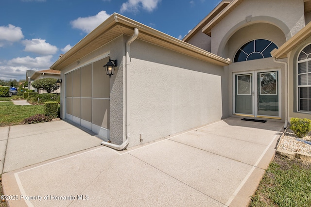 284 Quane Ave, Spring Hill, FL 34609 - doorway to property with stucco siding and a garage