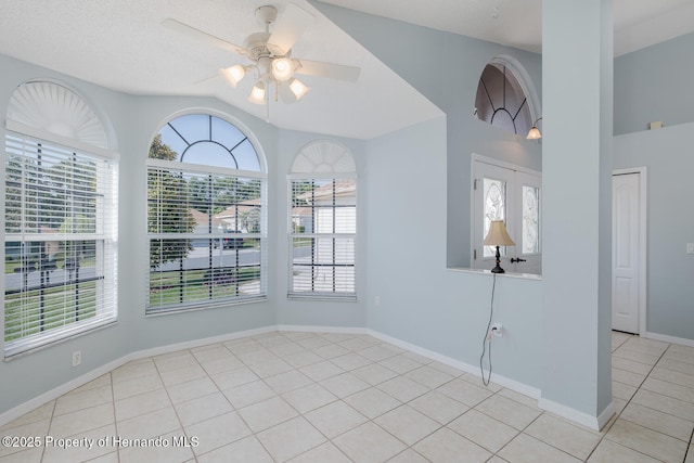 284 Quane Ave, Spring Hill, FL 34609 - unfurnished dining area featuring healthy amount of natural light, tile patterned floors, a ceiling fan, baseboards, and lofted ceiling