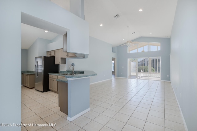 284 Quane Ave, Spring Hill, FL 34609 - kitchen featuring freestanding refrigerator, a ceiling fan, high vaulted ceiling, light tile patterned flooring, and a sink