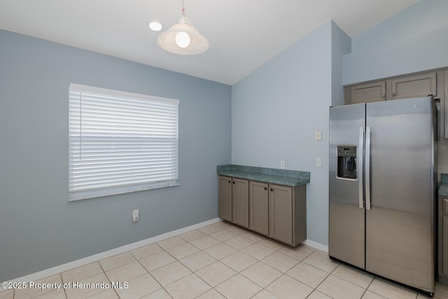 284 Quane Ave, Spring Hill, FL 34609 - kitchen with stainless steel refrigerator with ice dispenser, gray cabinetry, baseboards, and lofted ceiling