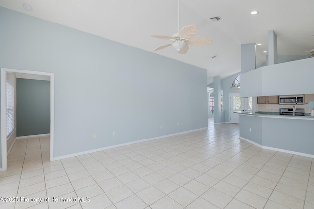 284 Quane Ave, Spring Hill, FL 34609 - unfurnished living room featuring light tile patterned flooring, ceiling fan, recessed lighting, high vaulted ceiling, and baseboards