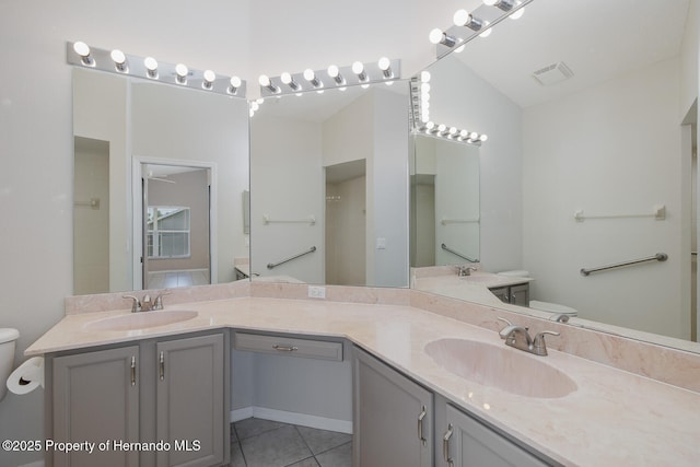284 Quane Ave, Spring Hill, FL 34609 - bathroom featuring toilet, tile patterned flooring, double vanity, and vaulted ceiling