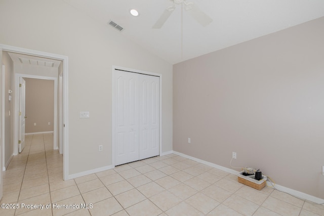284 Quane Ave, Spring Hill, FL 34609 - unfurnished bedroom featuring lofted ceiling, a closet, light tile patterned flooring, baseboards, and a ceiling fan