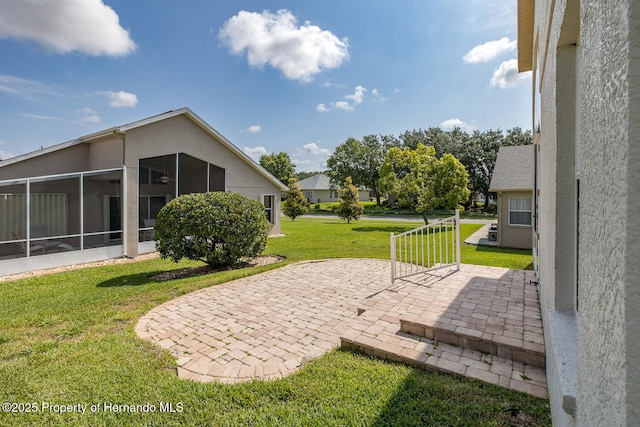 284 Quane Ave, Spring Hill, FL 34609 - view of green lawn featuring a patio and a sunroom