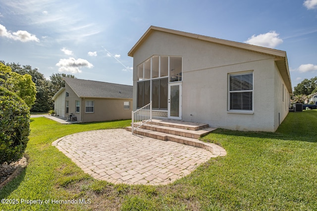 284 Quane Ave, Spring Hill, FL 34609 - rear view of house featuring a patio, stucco siding, and a lawn
