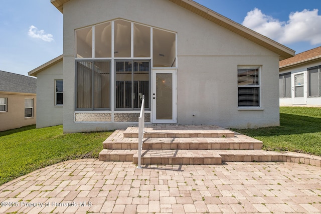 284 Quane Ave, Spring Hill, FL 34609 - rear view of house with stucco siding and a lawn