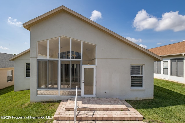 284 Quane Ave, Spring Hill, FL 34609 - rear view of house with stucco siding, a patio, and a yard
