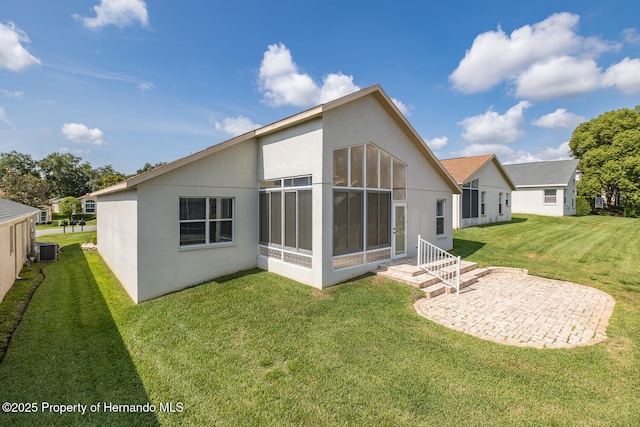 284 Quane Ave, Spring Hill, FL 34609 - back of house with stucco siding, central AC, a patio, and a yard