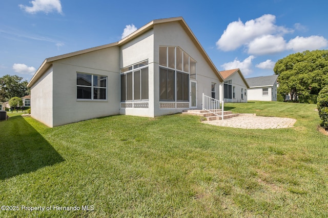 284 Quane Ave, Spring Hill, FL 34609 - rear view of property featuring stucco siding and a lawn