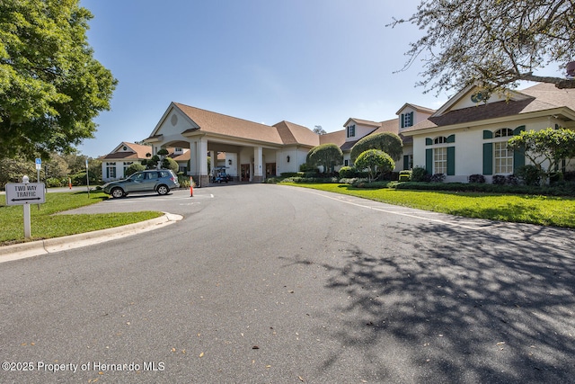 284 Quane Ave, Spring Hill, FL 34609 - view of front of house with uncovered parking, a front yard, and stucco siding