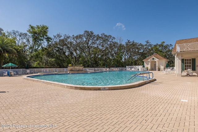 284 Quane Ave, Spring Hill, FL 34609 - community pool with fence, a patio area, and view of wooded area