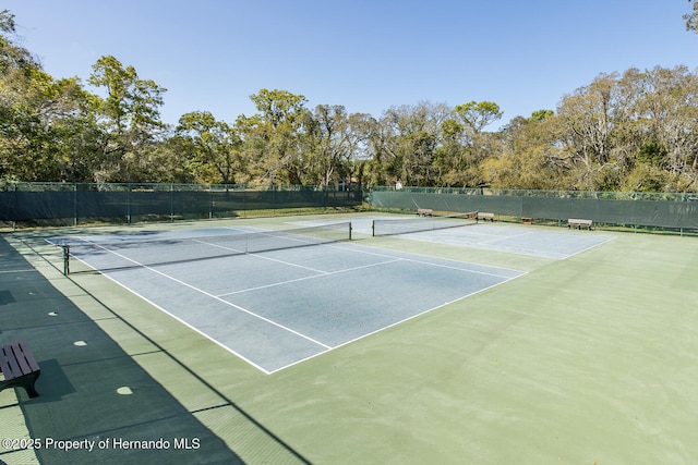 284 Quane Ave, Spring Hill, FL 34609 - view of tennis court with fence and view of scattered trees