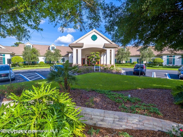 284 Quane Ave, Spring Hill, FL 34609 - view of front of property with a front yard, stucco siding, and uncovered parking